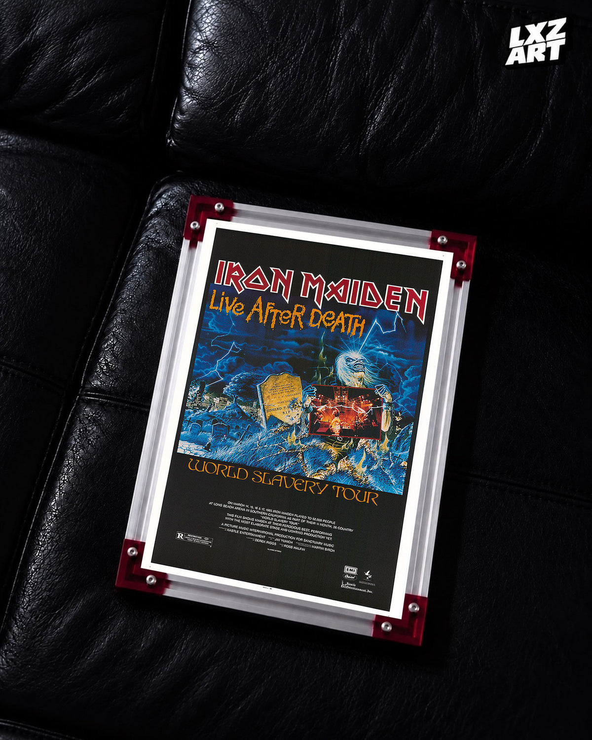 Iron Maiden Live After Death World Slavery Tour poster displayed on a black leather sofa in a red-corner frame; unframed print, frame not included