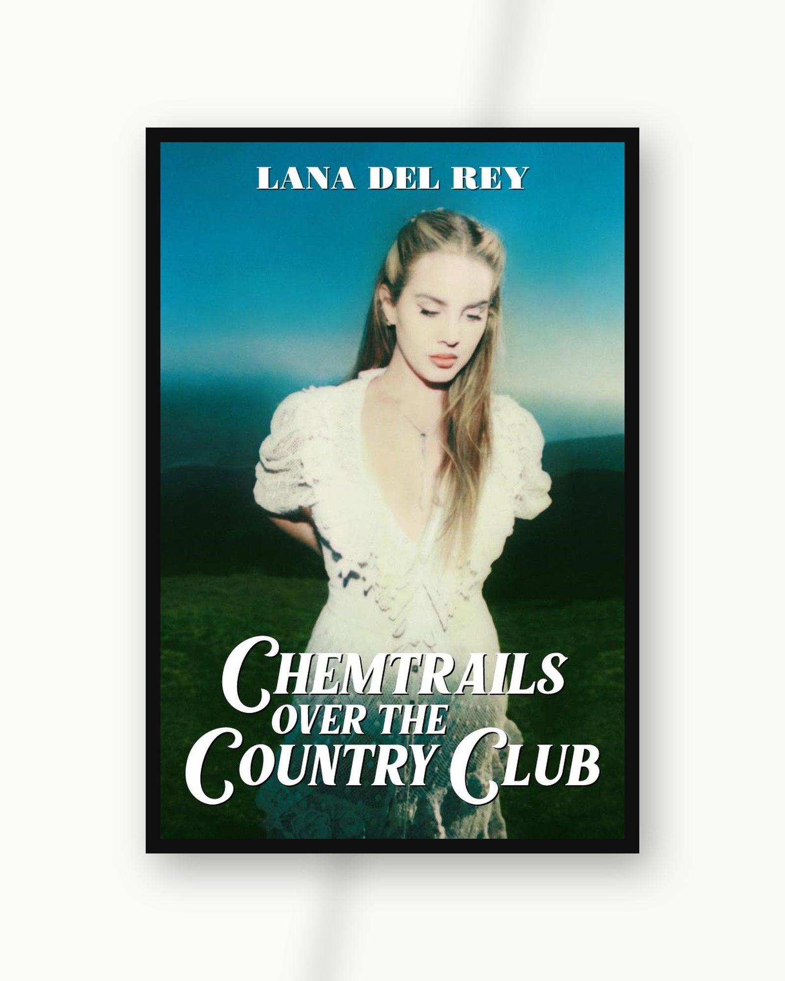 Lana Del Rey Chemtrails album poster in a black frame on a white wall; frame not included