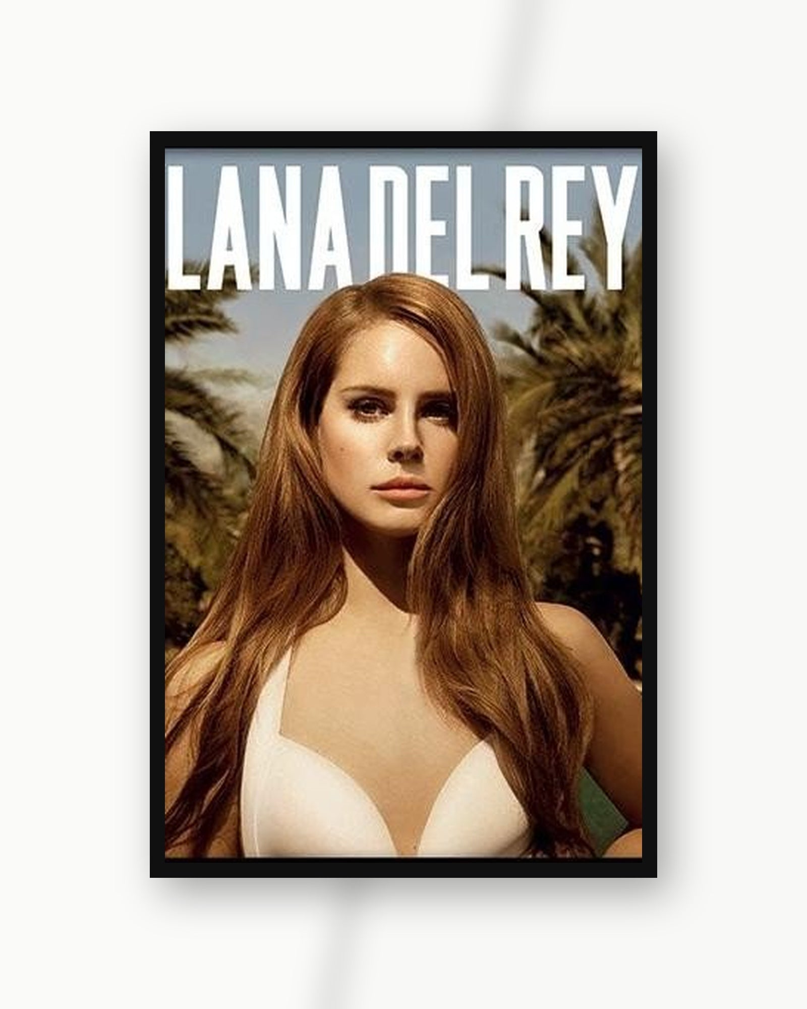Lana Del Rey Paradise album poster in a black frame on a white wall; frame not included