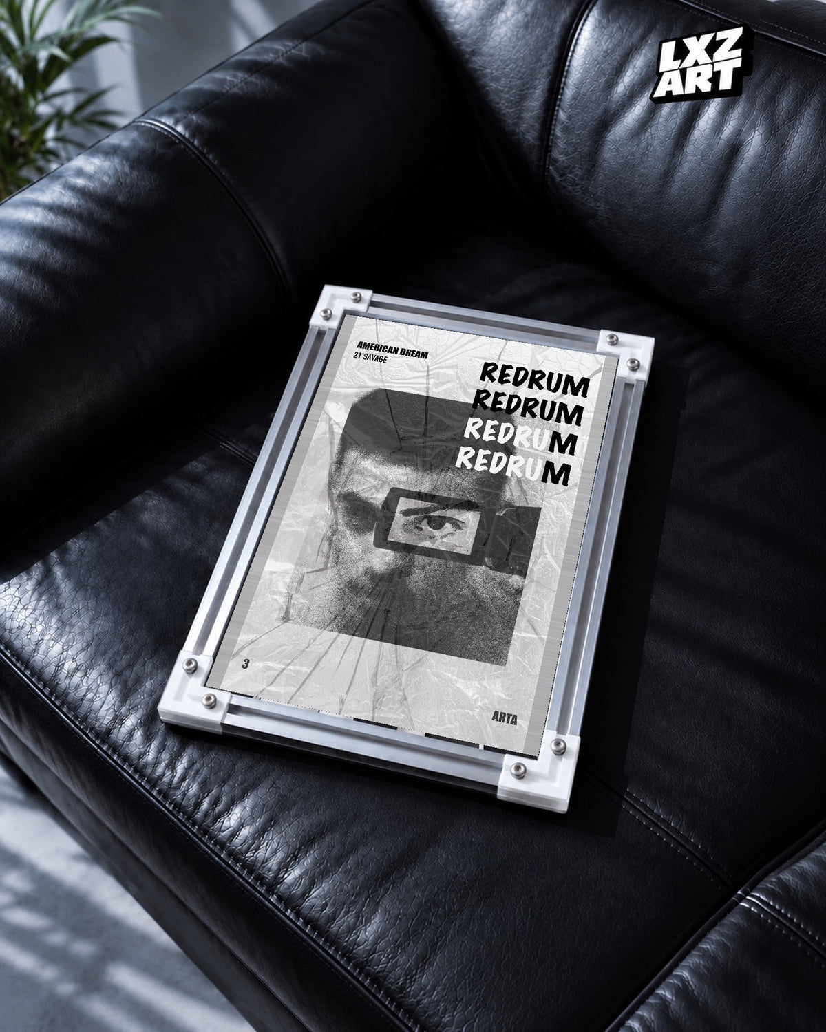 21 Savage Redrum Monochrome Eye Poster | Unframed Wall Art displayed on a black leather sofa; frame not included.