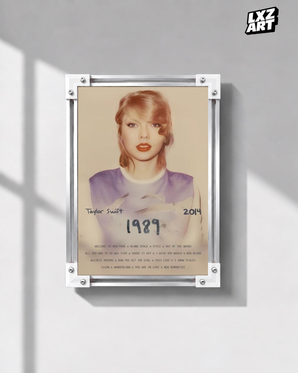 Taylor Swift 1989 Deluxe Edition Poster in white-corner frame on gray wall. Frame shown for display only.
