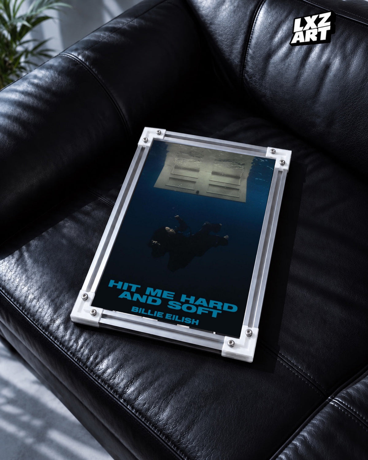 Billie Eilish Hit Me Hard and Soft Album Poster in white-corner frame on black leather sofa. Frame shown for display only.