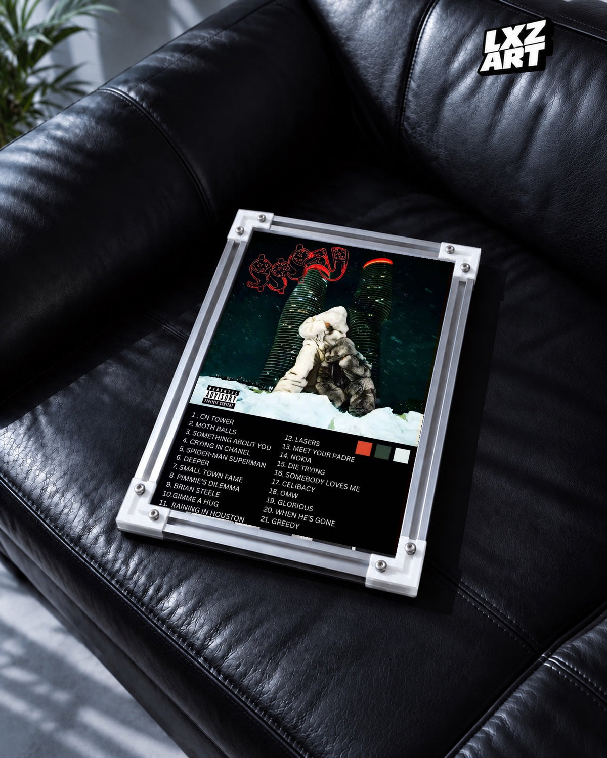 Drake Fan Concept Album Tracklist Poster in white-corner frame on black leather sofa. Frame shown for display only.