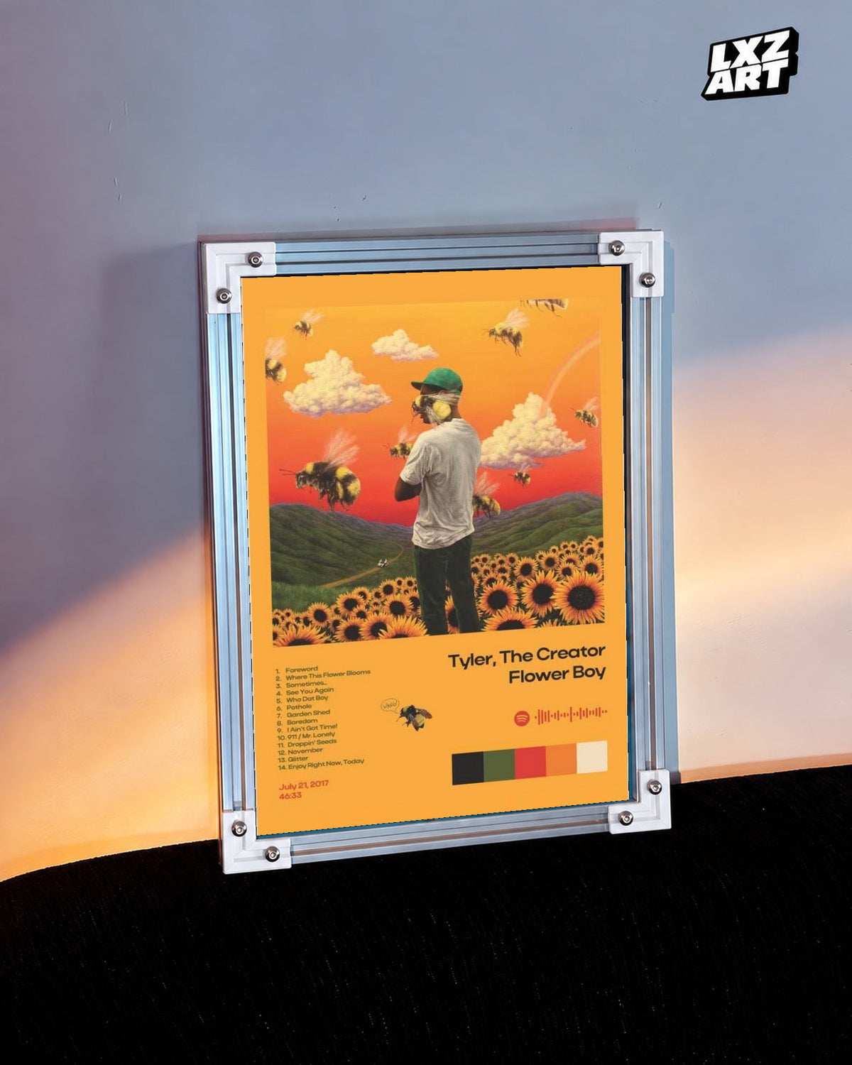 Tyler, The Creator Flower Boy Tracklist Poster in white-corner frame on warm-lit wall. Frame shown for display only.