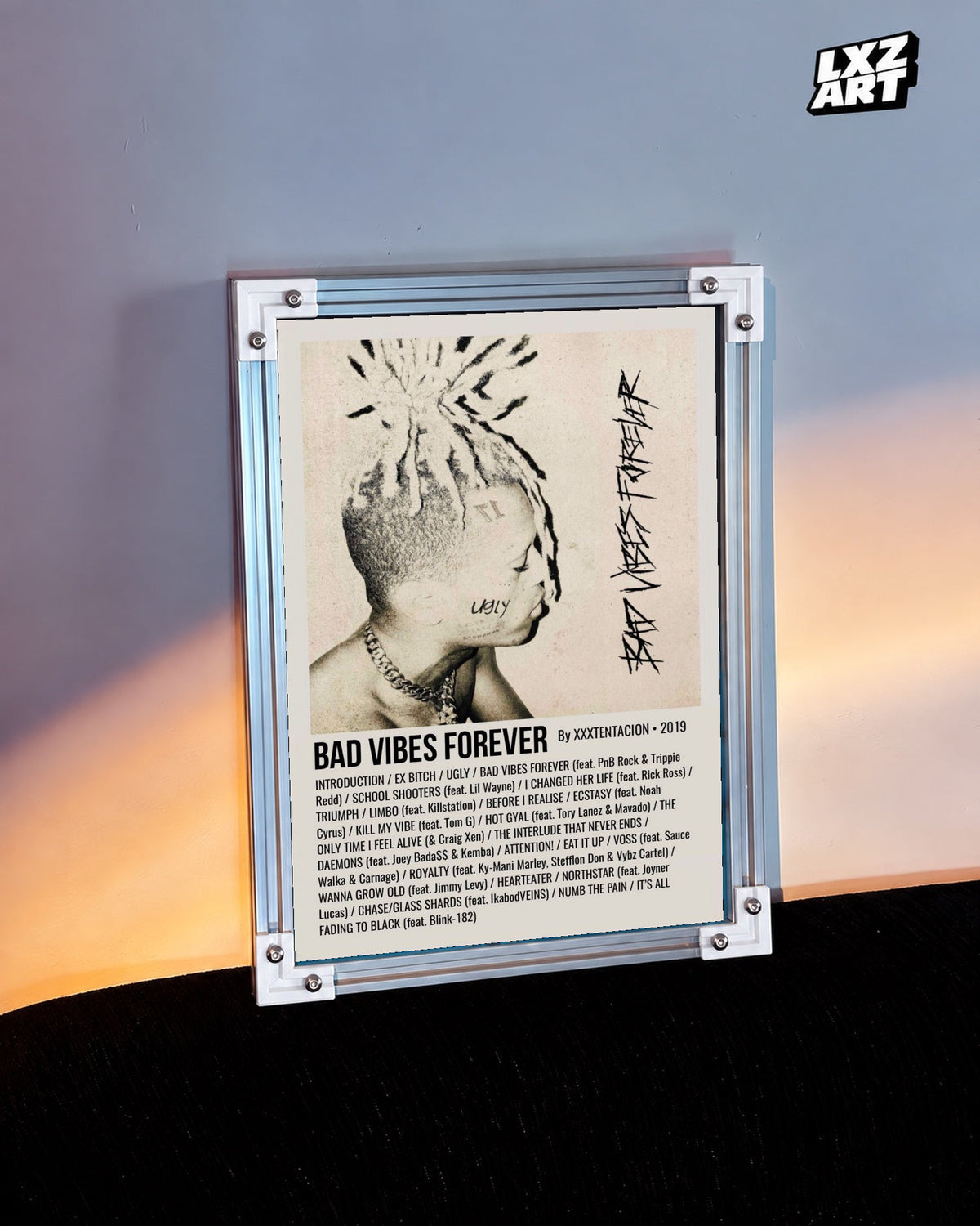 XXXTentacion Bad Vibes Forever Album Tracklist Poster in white-corner frame beside warm-lit wall. Frame shown for display only.