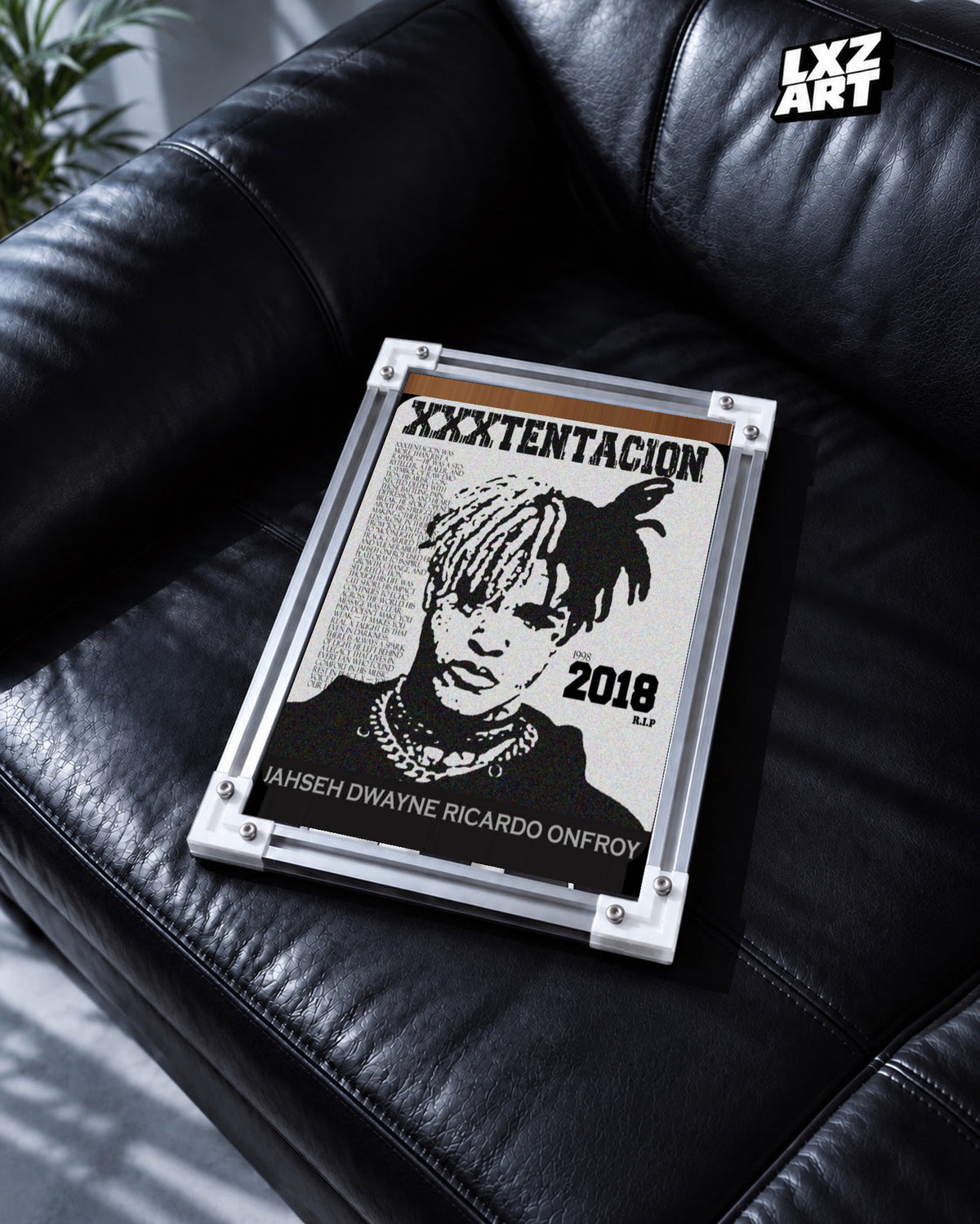 XXXTentacion 1998–2018 Memorial Portrait Poster in white-corner frame on black leather sofa. Frame shown for display only.