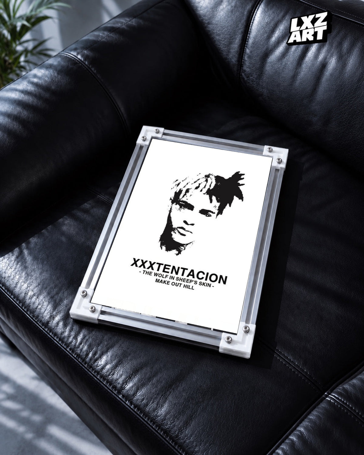 XXXTentacion Make Out Hill Minimal Portrait Poster in white-corner frame on black leather sofa. Frame shown for display only.