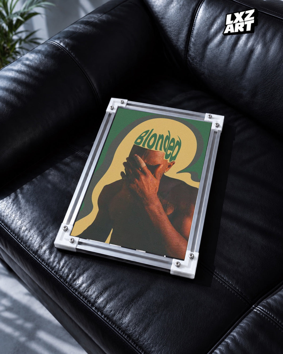 Frank Ocean Blonde Retro Portrait Poster in white-corner frame on black leather sofa. Frame shown for display only.