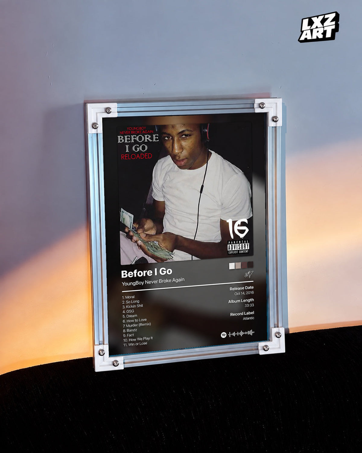 YoungBoy Never Broke Again Before I Go Tracklist Poster in white-corner frame on warm-lit wall. Frame shown for display only.