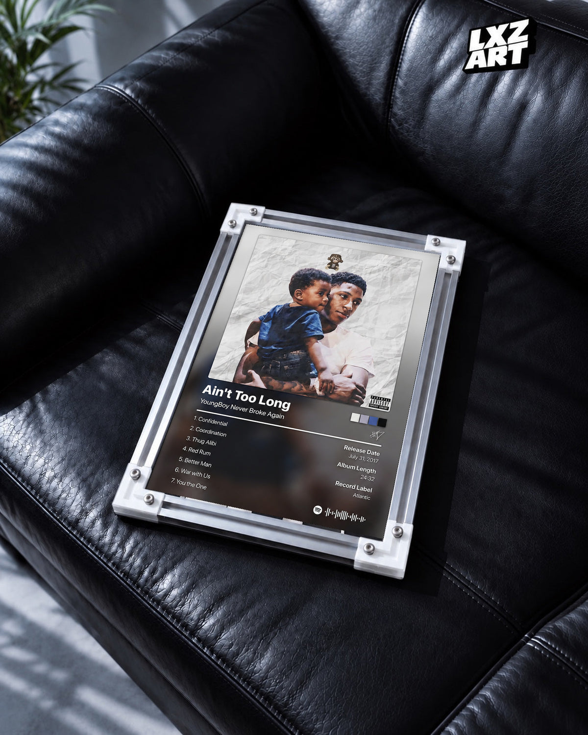 YoungBoy Never Broke Again Ain't Too Long Tracklist Poster in white-corner frame on black leather sofa. Frame shown for display only.
