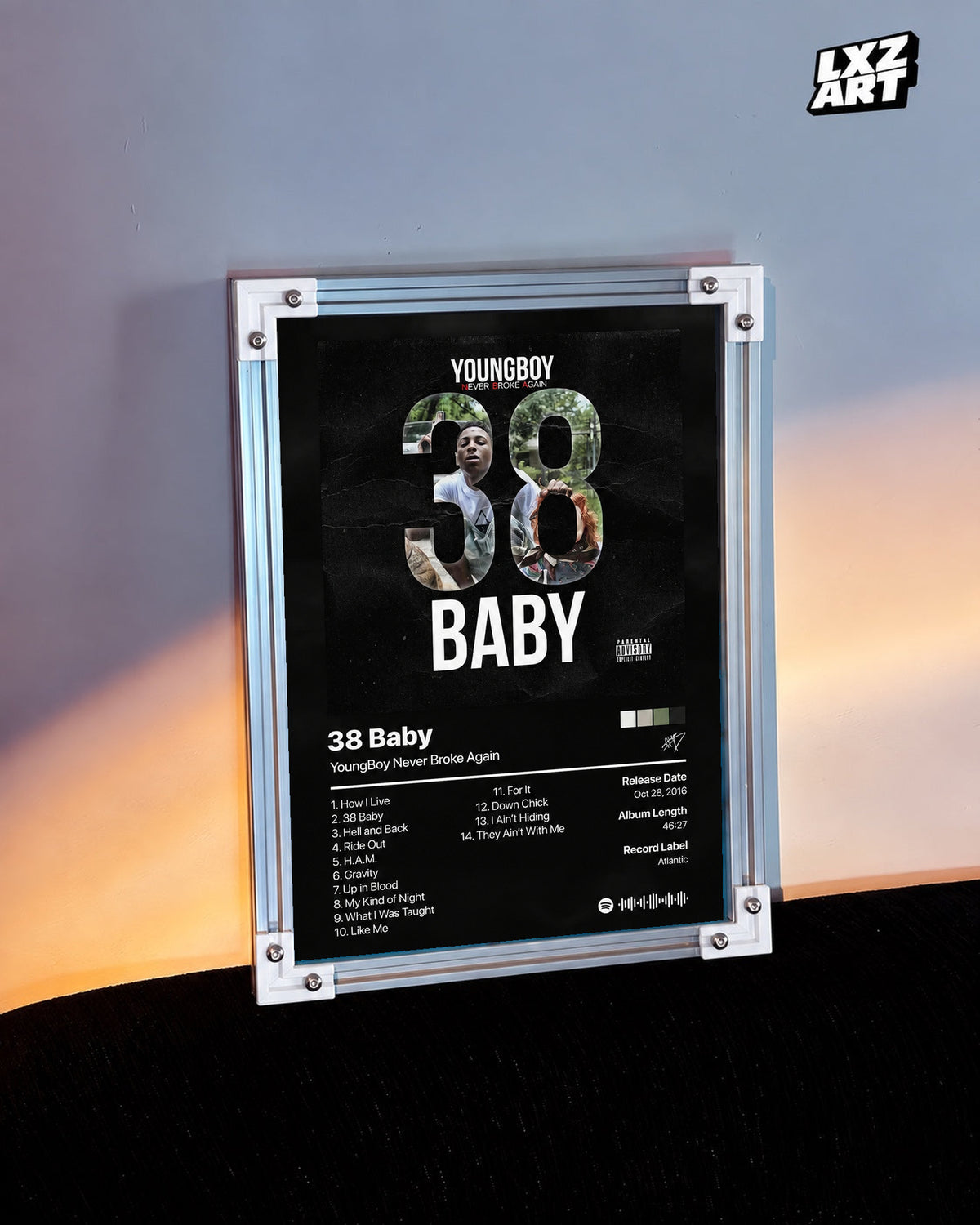 YoungBoy Never Broke Again 38 Baby Tracklist Poster in white-corner frame on warm-lit wall. Frame shown for display only.