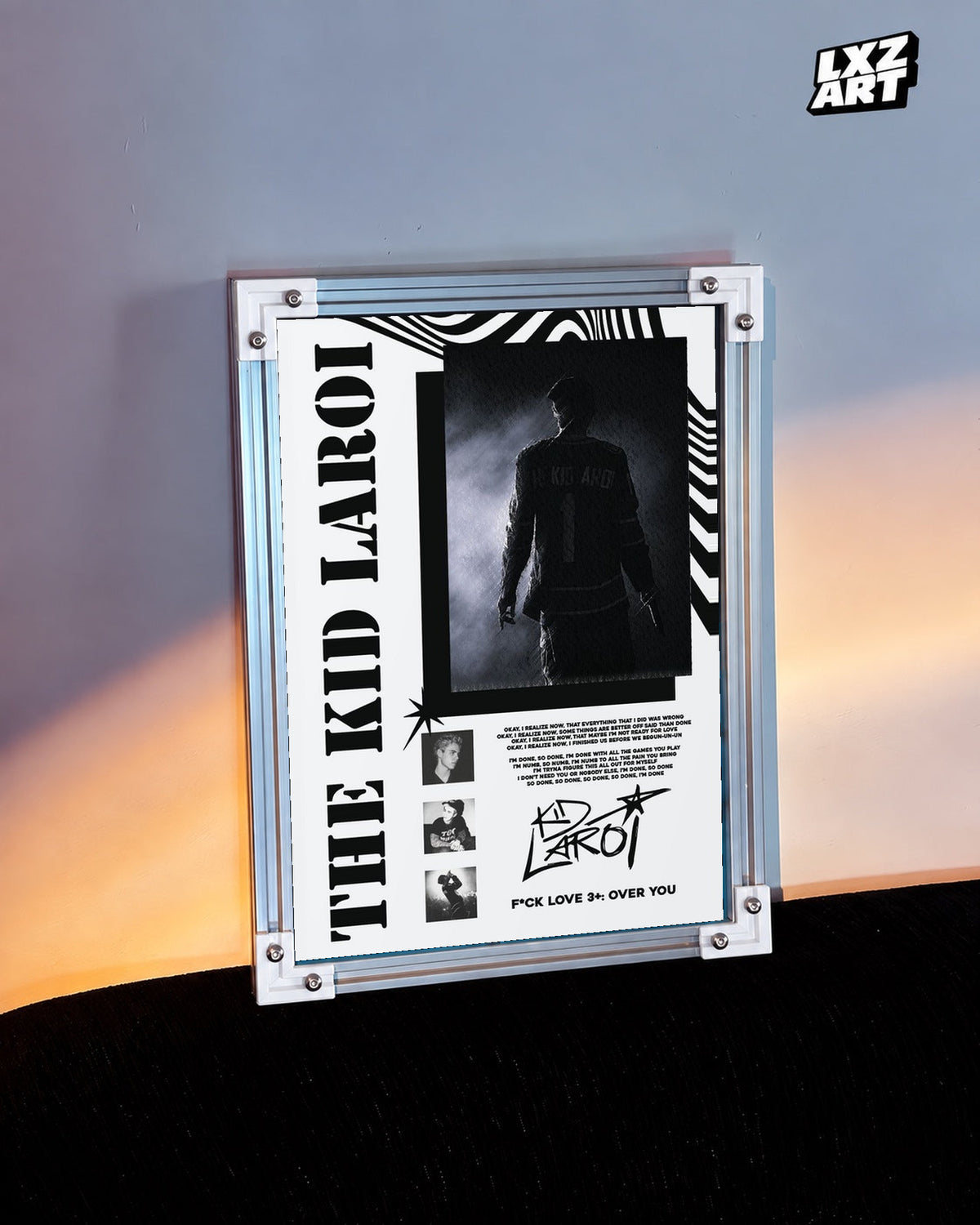 The Kid LAROI FLV3+: OVER YOU Black and White Collage Poster in white-corner frame beside warm-lit wall. Frame shown for display only.