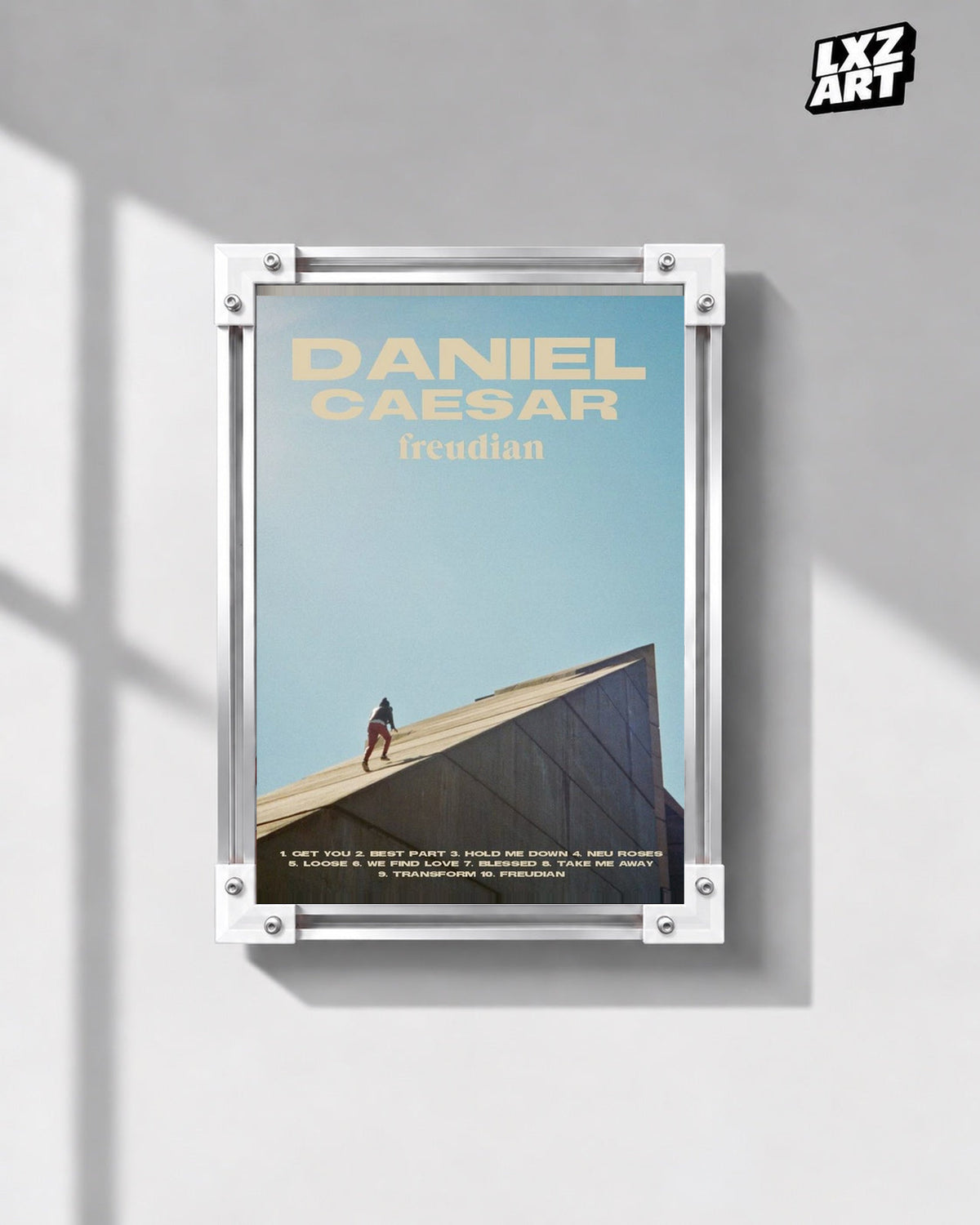 Daniel Caesar Freudian Sky Blue Album Poster in white-corner frame on gray wall. Frame shown for display only.