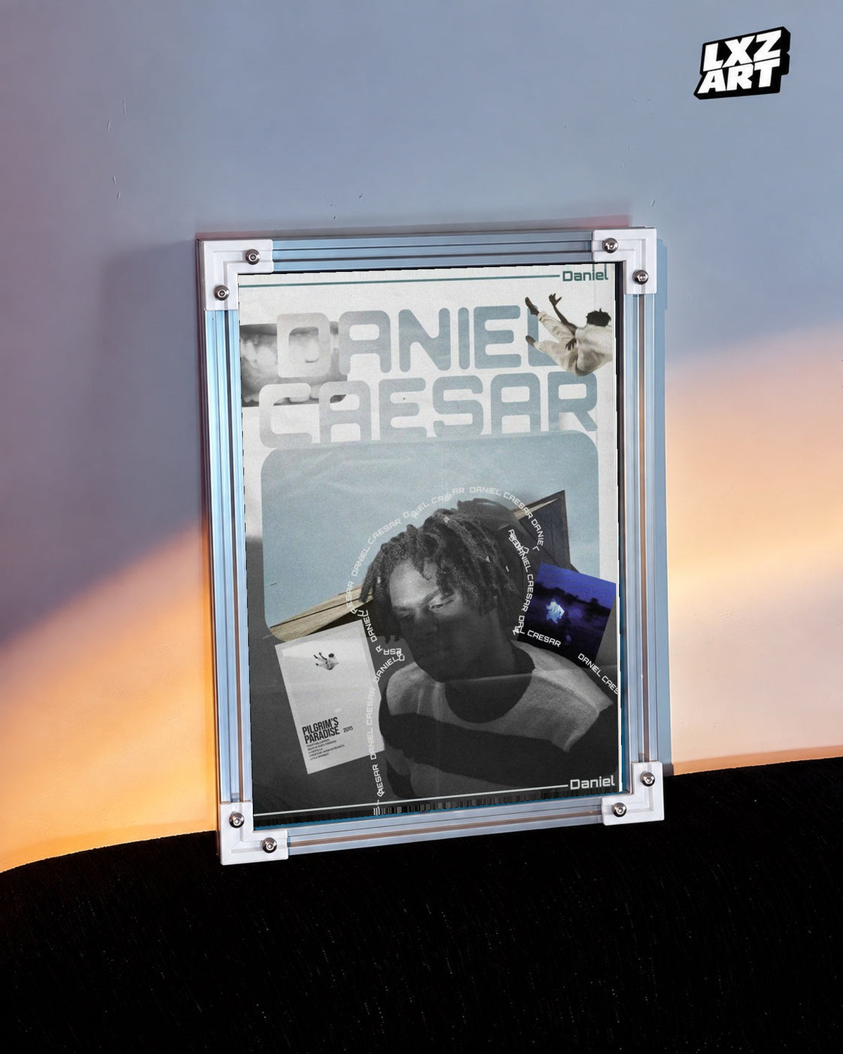 Daniel Caesar Blue Album Collage Poster in white-corner frame beside warm-lit wall. Frame shown for display only.