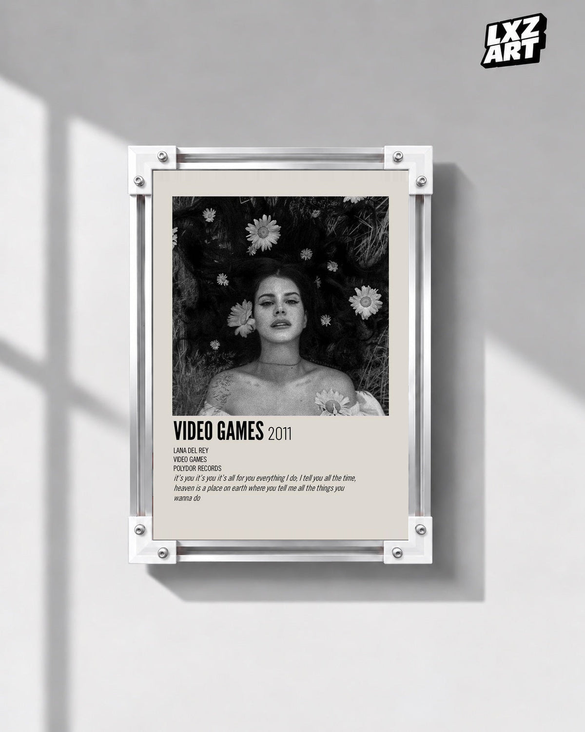 Lana Del Rey Video Games Monochrome Floral Portrait Poster in white-corner frame on gray wall. Frame shown for display only.