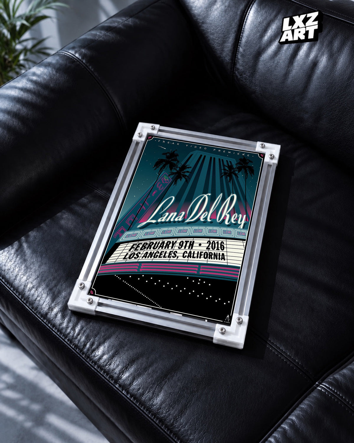 Lana Del Rey Freak Video Premiere Art Deco Poster in white-corner frame on black leather sofa. Frame shown for display only.