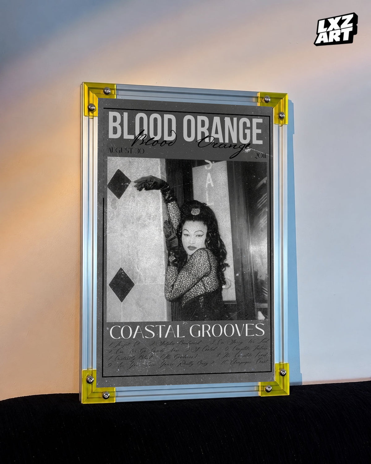 Blood Orange Coastal Grooves monochrome script poster displayed against a warm-lit wall in the yellow-corner frame; unframed print, frame not included