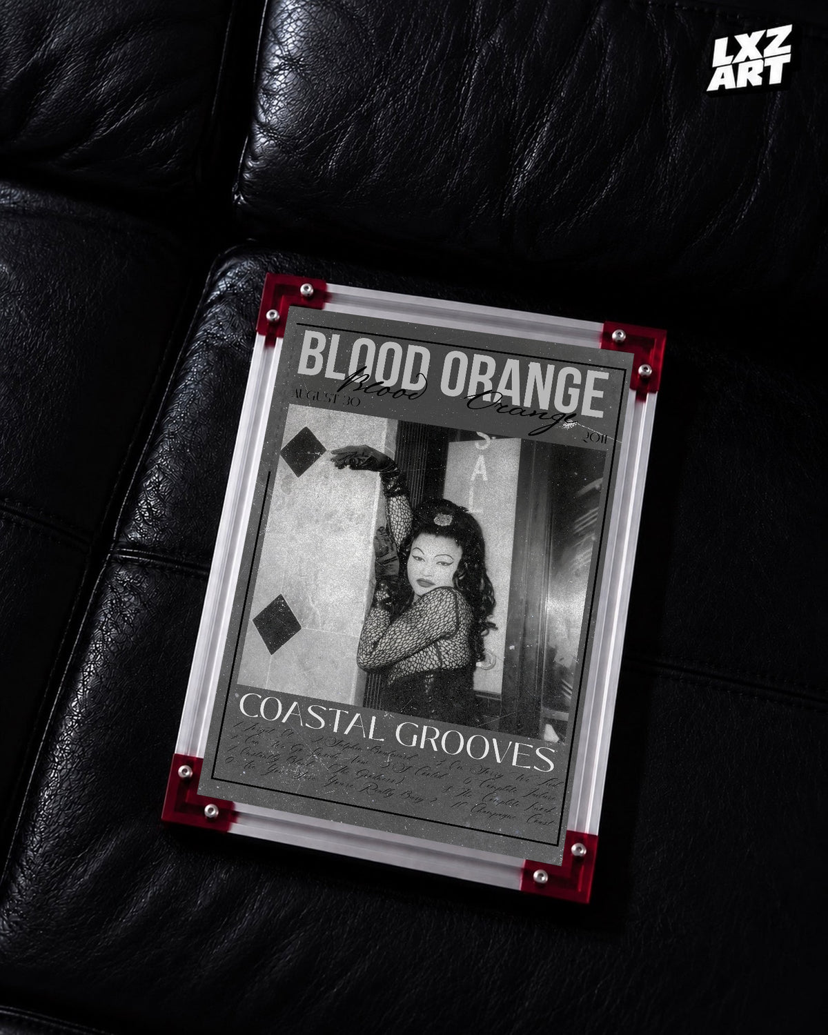 Blood Orange Coastal Grooves monochrome script poster displayed on a black leather sofa in the red-corner frame; unframed print, frame not included