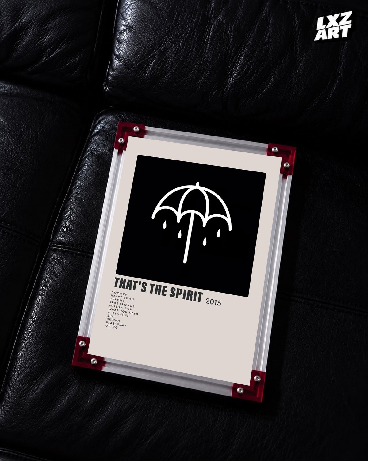 Bring Me The Horizon That's the Spirit umbrella tracklist poster displayed on a black leather sofa in a red-corner frame; unframed print, frame not included