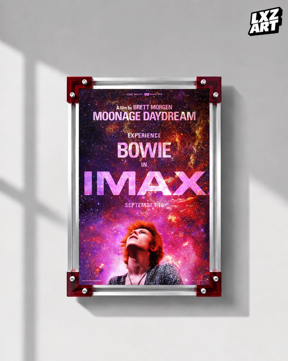 David Bowie Moonage Daydream IMAX Galaxy poster displayed on gray wall with red frame corners; frame not included