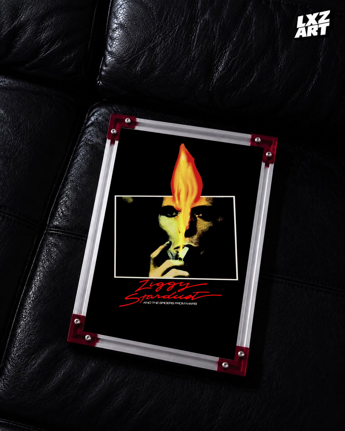 David Bowie Ziggy Stardust Flame Portrait poster displayed on black leather sofa with red frame corners; frame not included