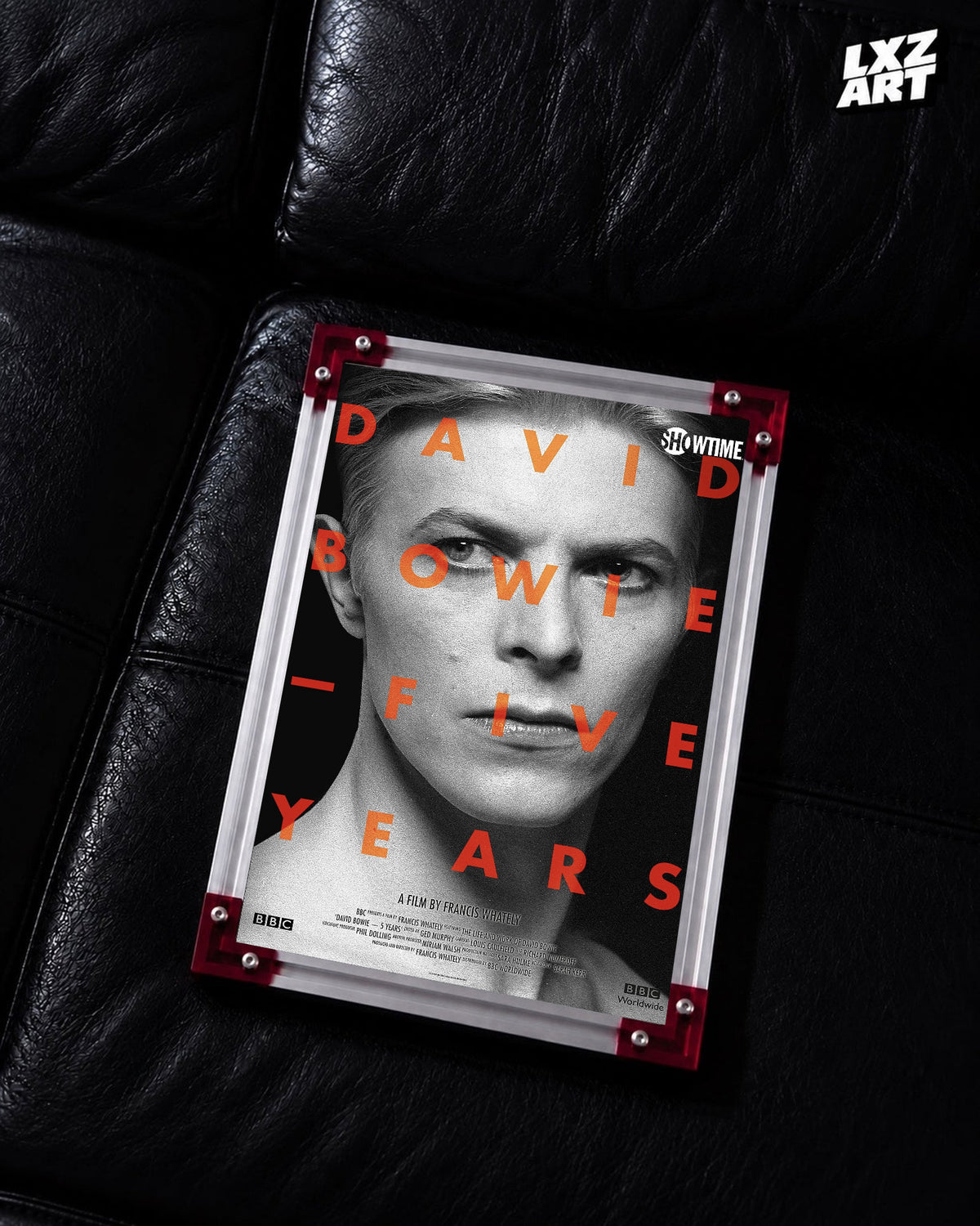 David Bowie Five Years Monochrome Portrait poster displayed on black leather sofa with red frame corners; frame not included