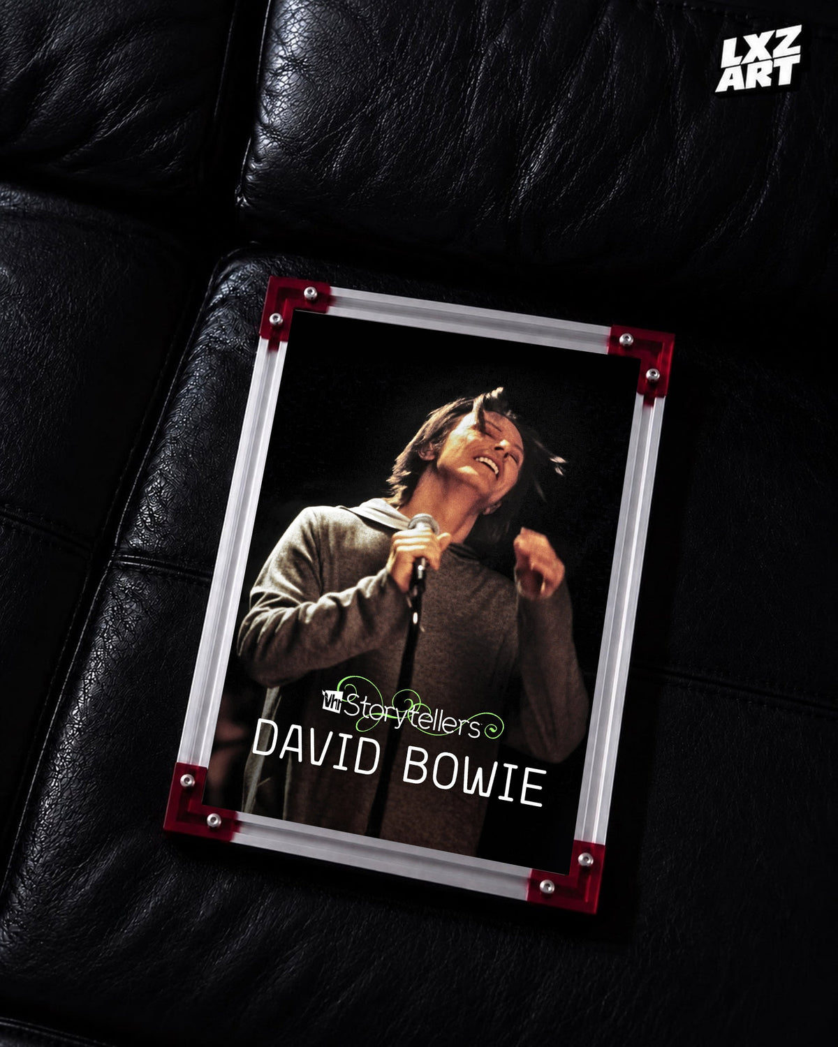 David Bowie VH1 Storytellers Live Portrait poster displayed on black leather sofa with red frame corners; frame not included
