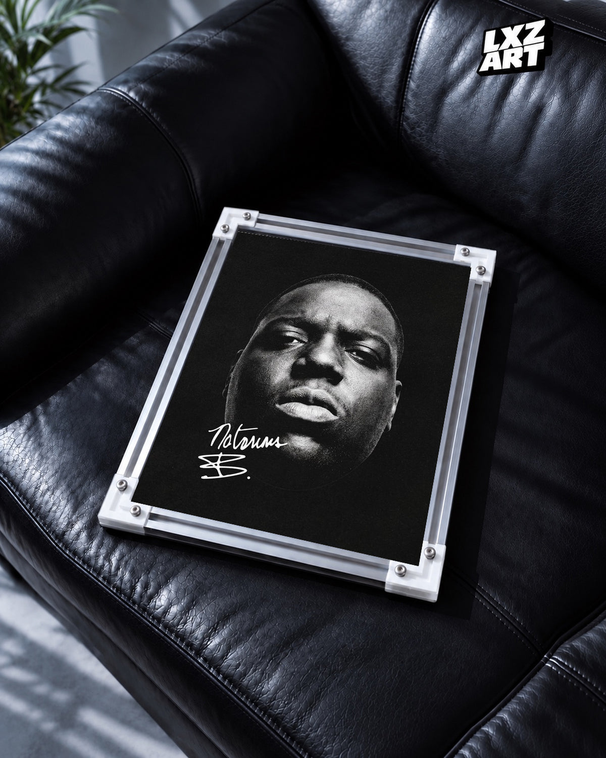The Notorious B.I.G. Black and White Close-Up Portrait Poster | Unframed — black leather sofa display; unframed print, frame not included
