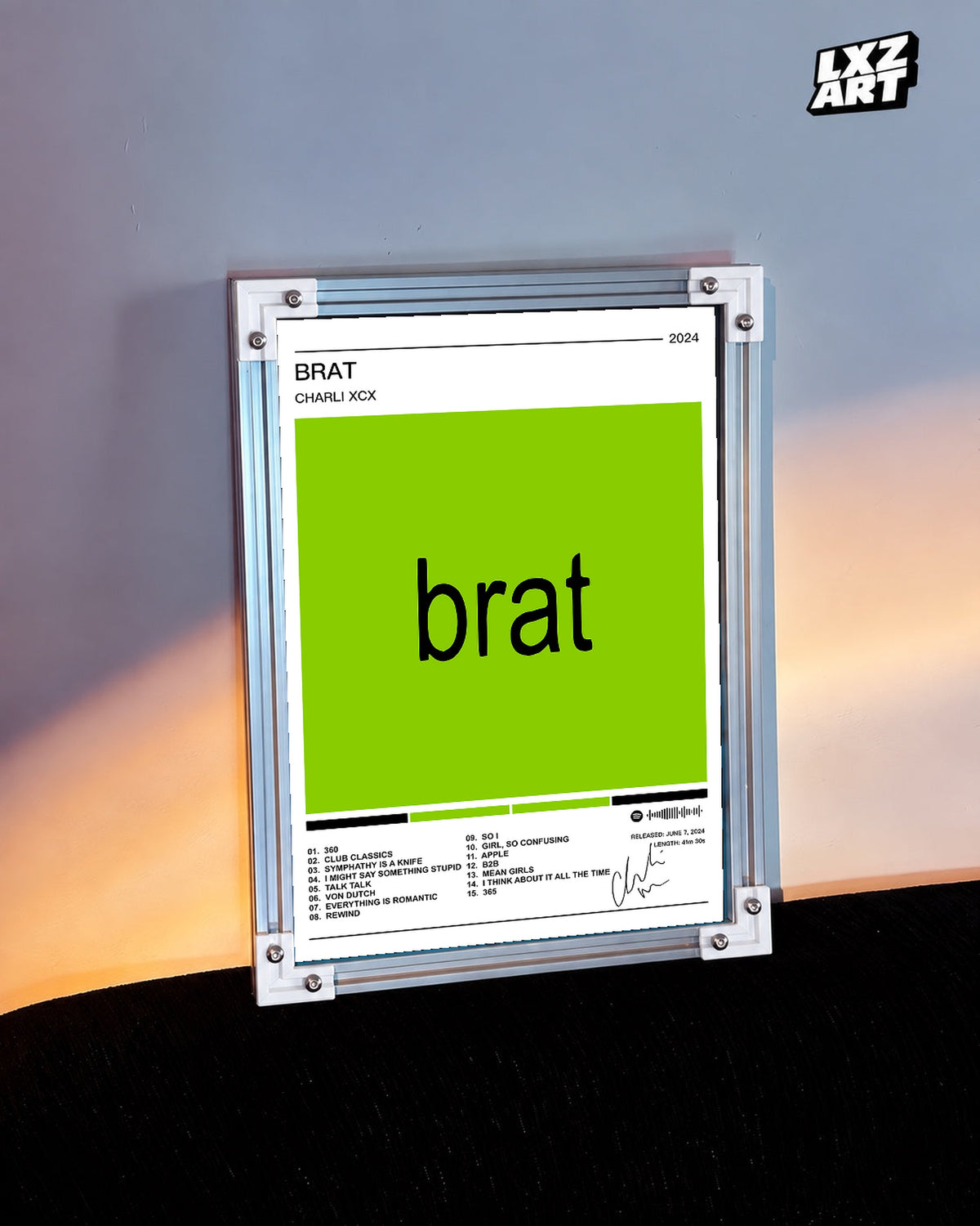 Charli xcx Brat White Tracklist unframed poster shown in the warm-lit wall display.