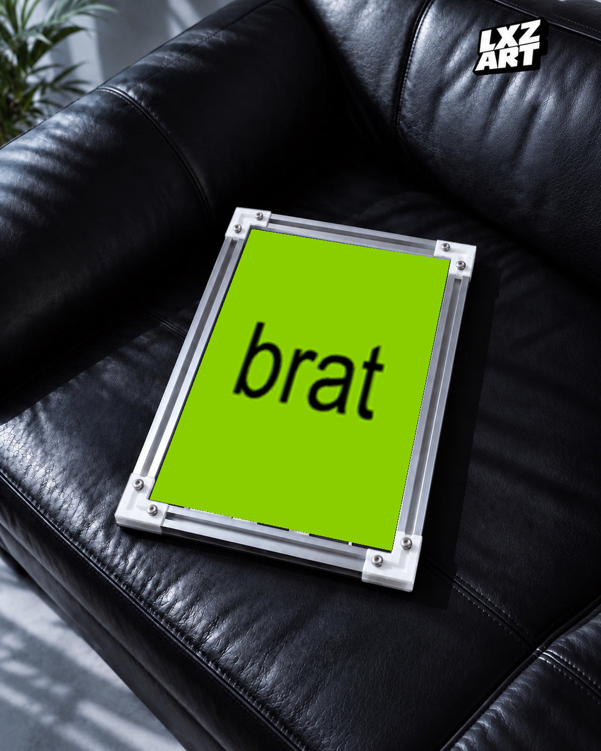 Charli xcx Brat Minimal Green Typography unframed poster shown in the black leather sofa display.