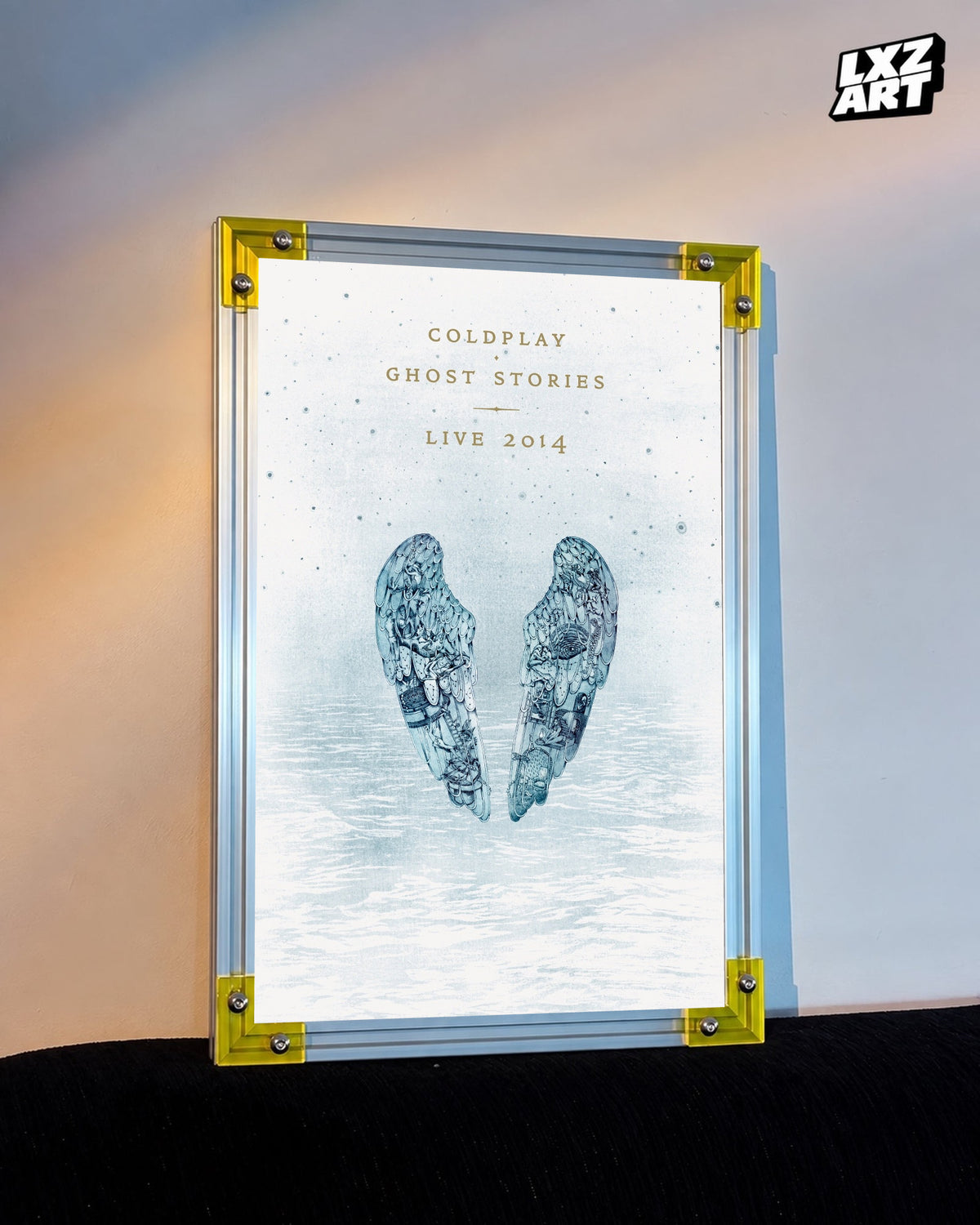 Coldplay Ghost Stories Live 2014 Poster displayed against a warm wall in a yellow-corner frame; unframed print, frame not included