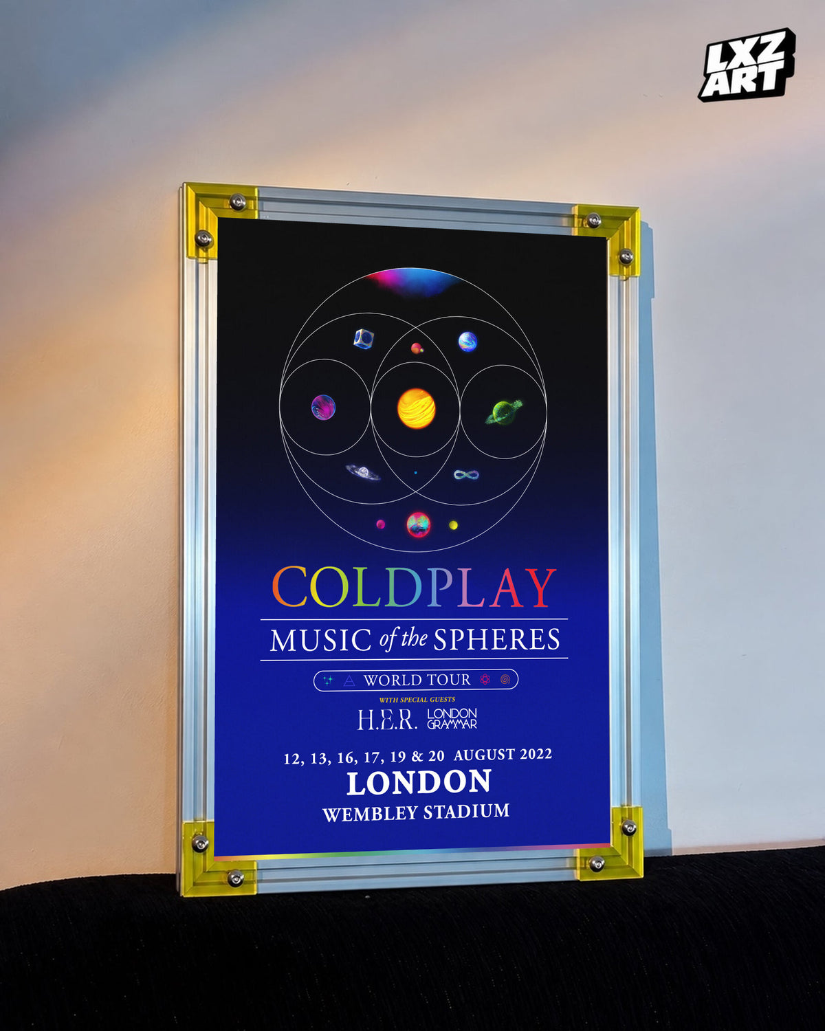 Coldplay Music of the Spheres London 2022 Tour Poster displayed against a warm wall in a yellow-corner frame; unframed print, frame not included
