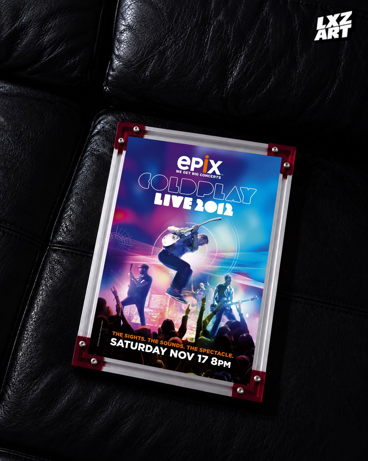 Coldplay Live 2012 Epix TV Special Poster displayed on a black leather sofa in a red-corner frame; unframed print, frame not included
