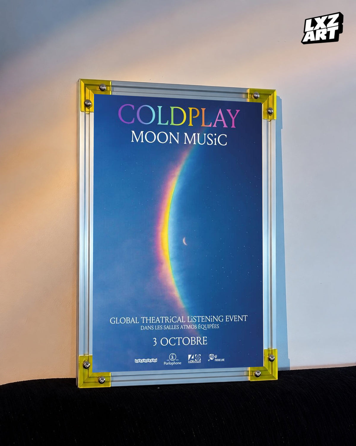 Coldplay Moon Music Global Theatrical Listening Event Poster displayed against a warm wall in a yellow-corner frame; unframed print, frame not included