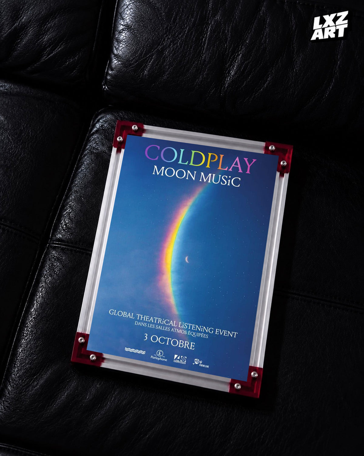 Coldplay Moon Music Global Theatrical Listening Event Poster displayed on a black leather sofa in a red-corner frame; unframed print, frame not included