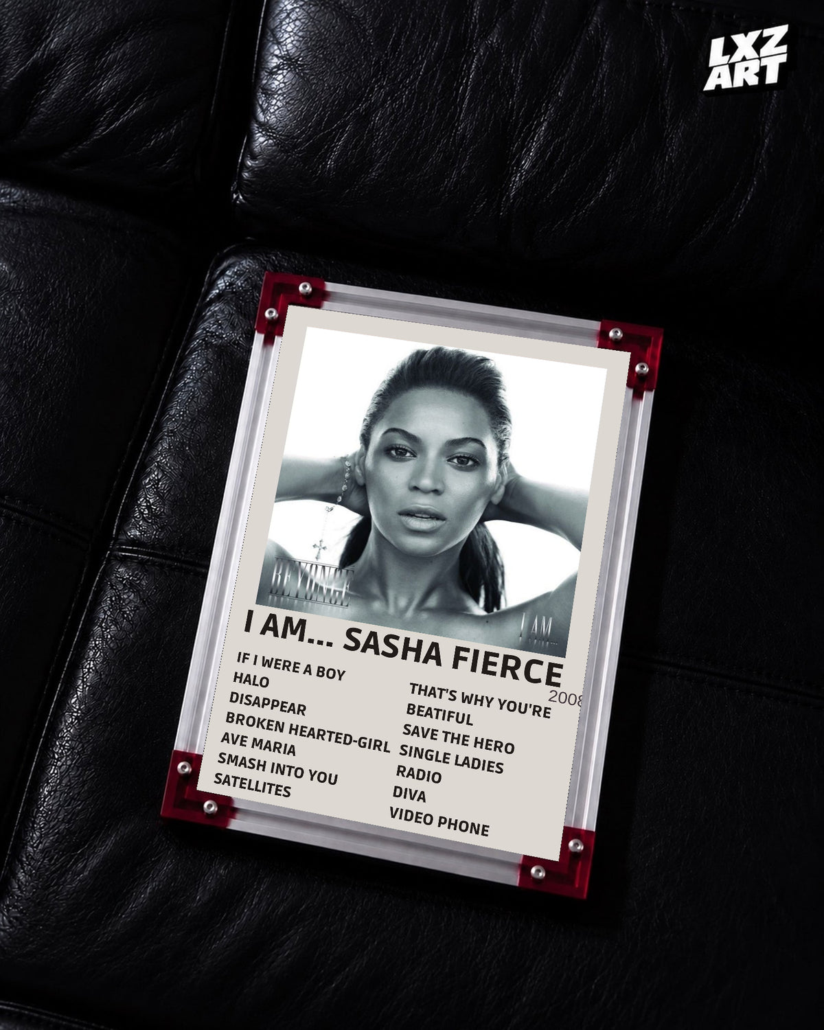 Beyoncé I Am... Sasha Fierce tracklist poster displayed on a black leather sofa in a red corner frame; unframed print, frame not included