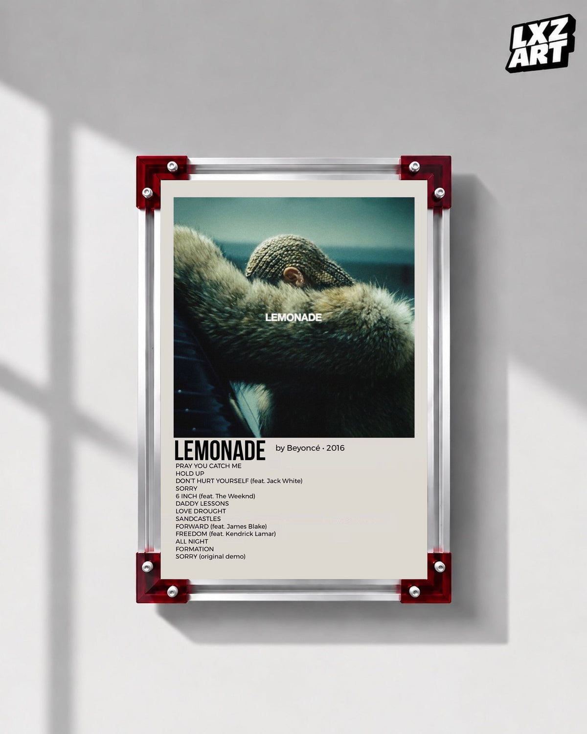 Beyoncé Lemonade tracklist poster displayed on a gray wall in a red corner frame; unframed print, frame not included