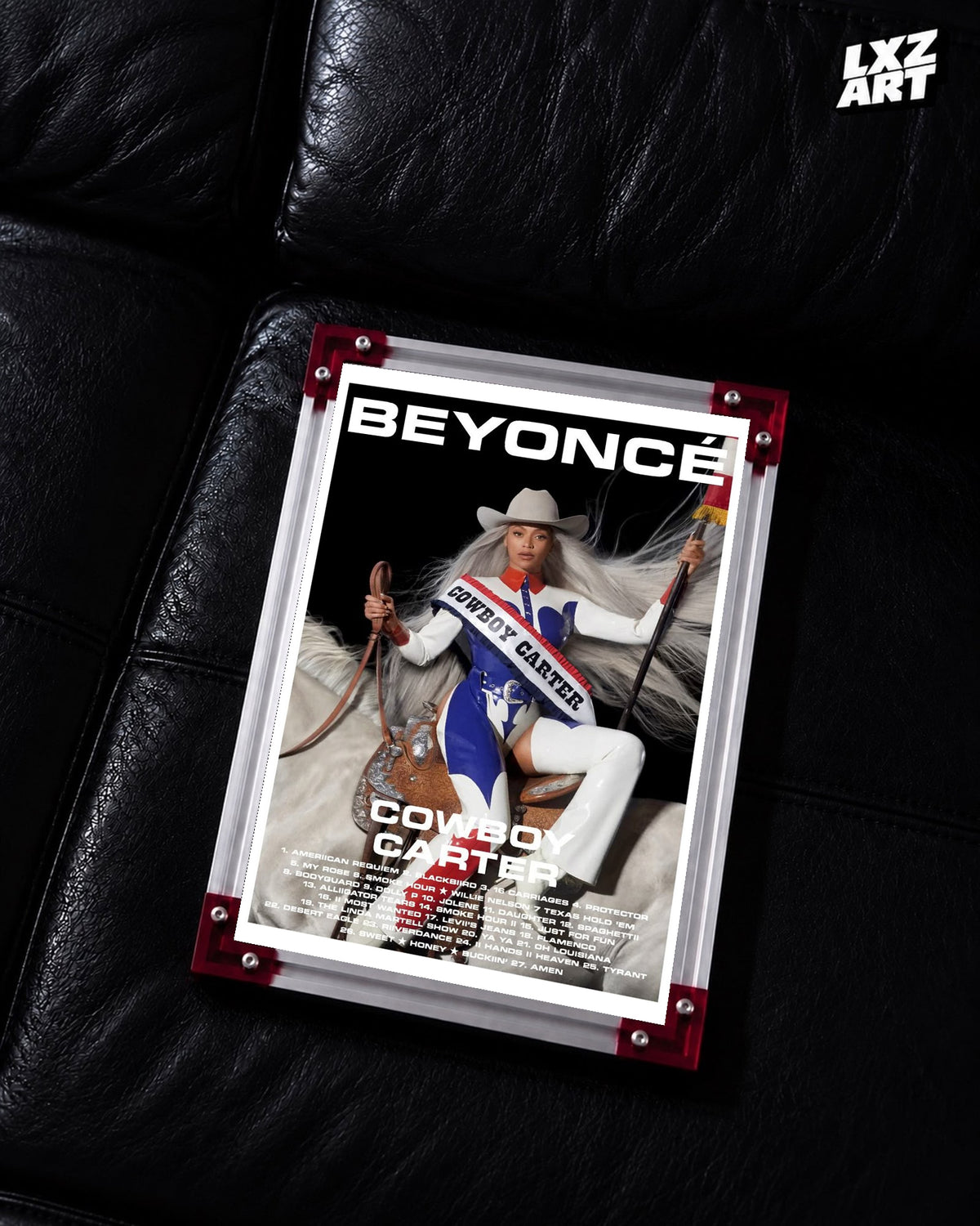 Beyoncé Cowboy Carter tracklist poster displayed on a black leather sofa in a red corner frame; unframed print, frame not included
