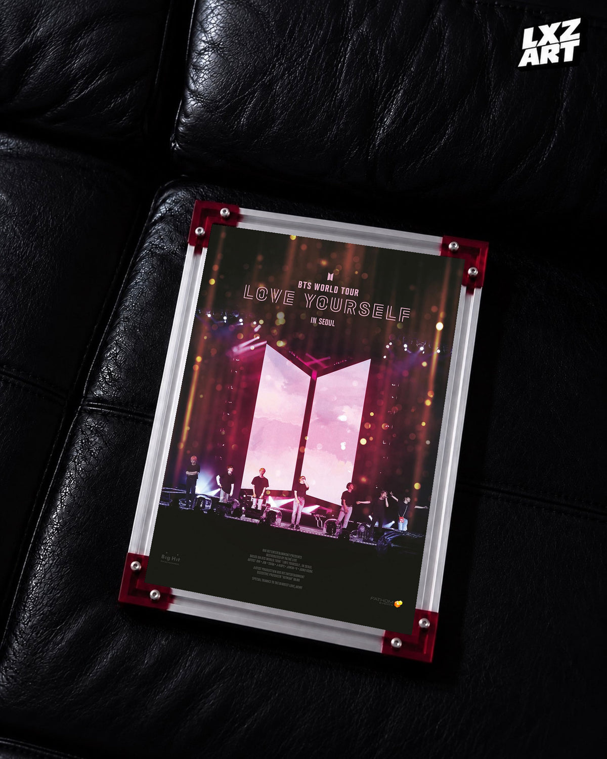 BTS World Tour Love Yourself in Seoul concert film poster displayed on a black leather sofa in a red-corner frame; unframed print, frame not included