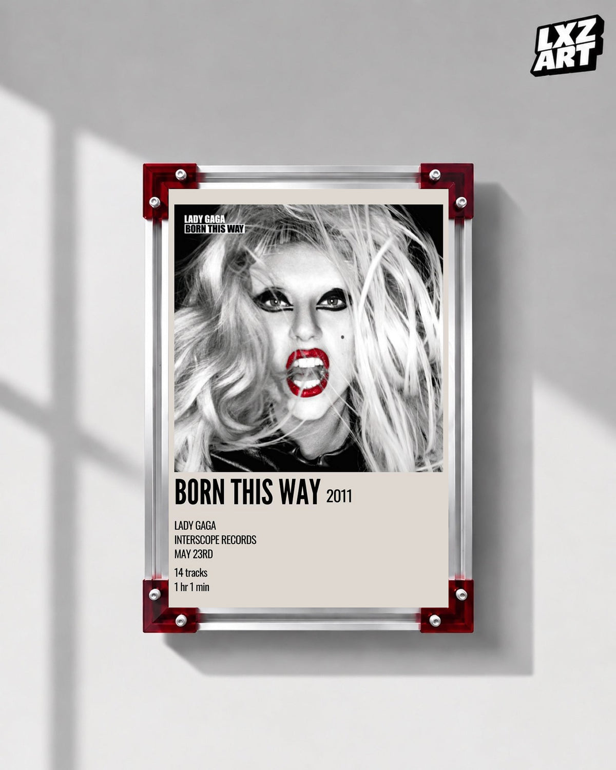 Lady Gaga Born This Way album cover poster displayed on a gray wall in a red corner frame; unframed print, frame not included