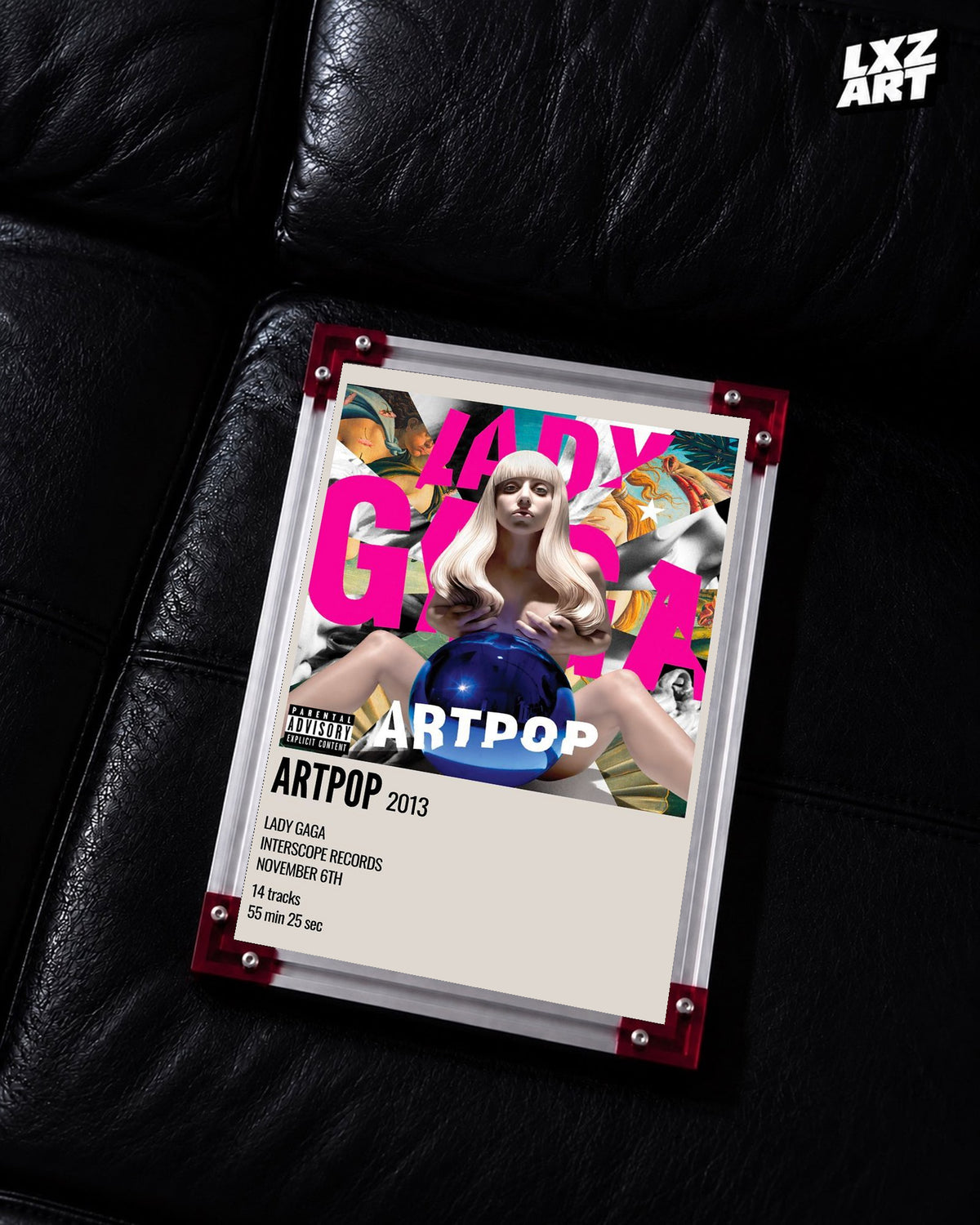 Lady Gaga ARTPOP album cover poster displayed on a black leather sofa in a red corner frame; unframed print, frame not included