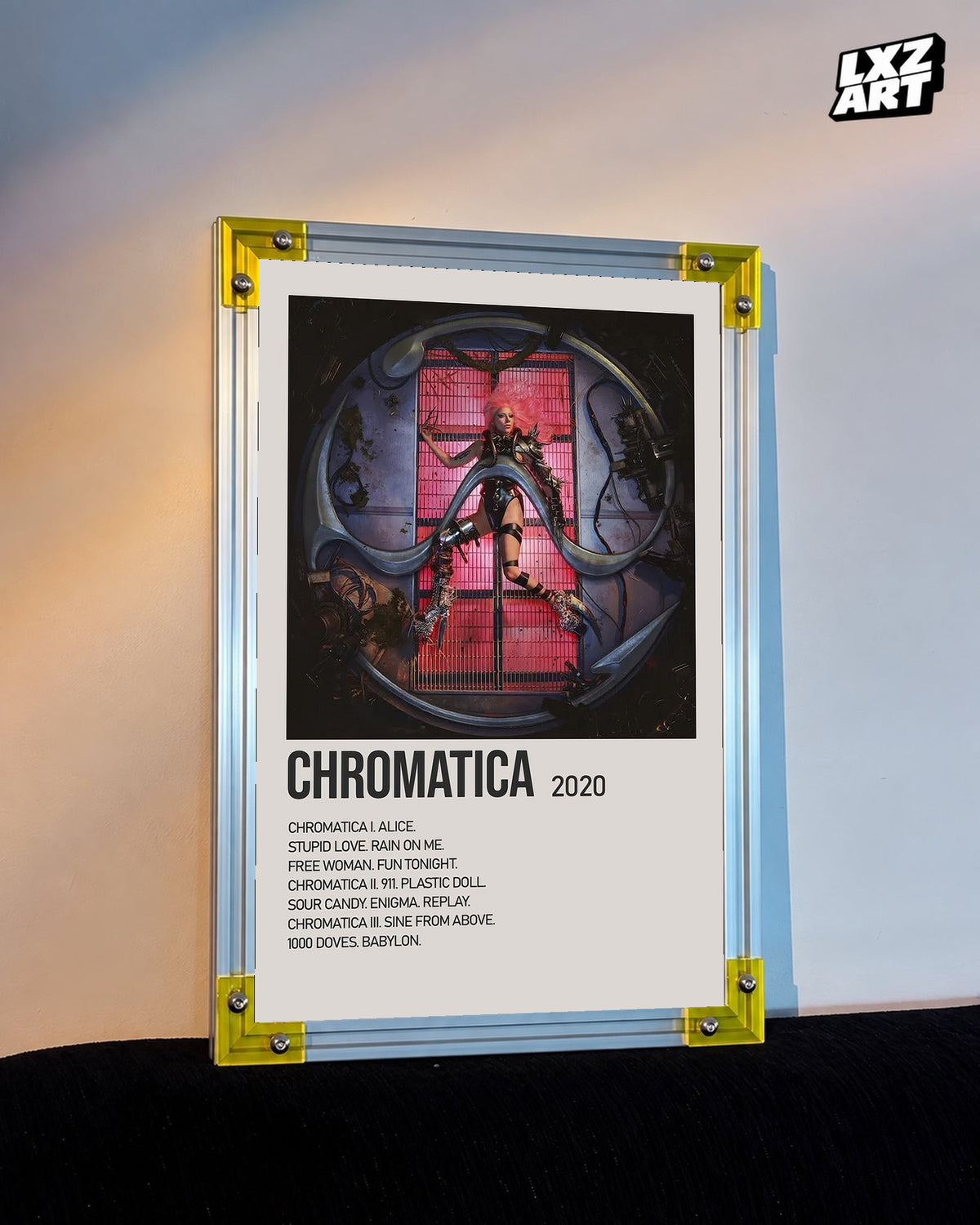 Lady Gaga Chromatica tracklist poster displayed against a warm wall in a yellow corner frame; unframed print, frame not included