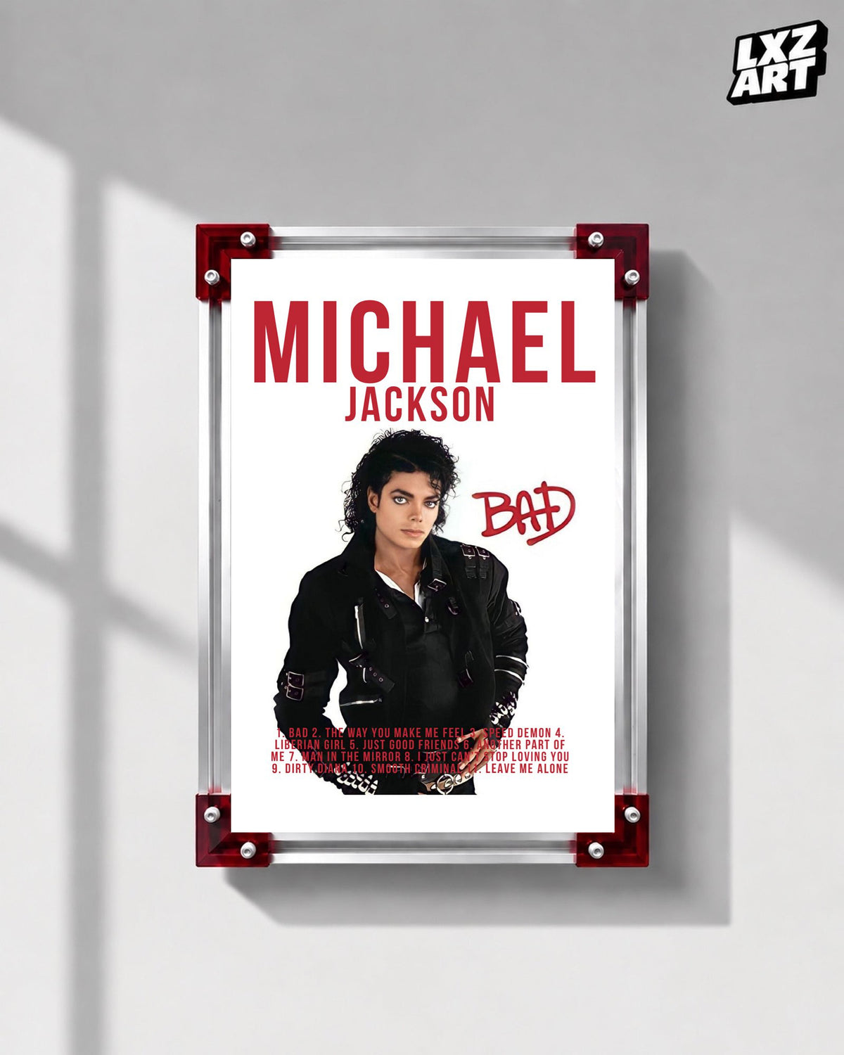 Michael Jackson Bad Red Typography tracklist poster displayed on a gray wall in a red corner frame; unframed print, frame not included
