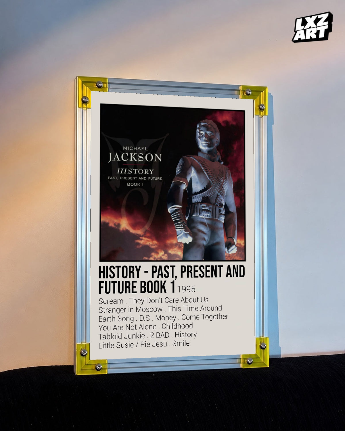 Michael Jackson HIStory Past, Present and Future Book I tracklist poster displayed against a warm wall in a yellow corner frame; unframed print, frame not included