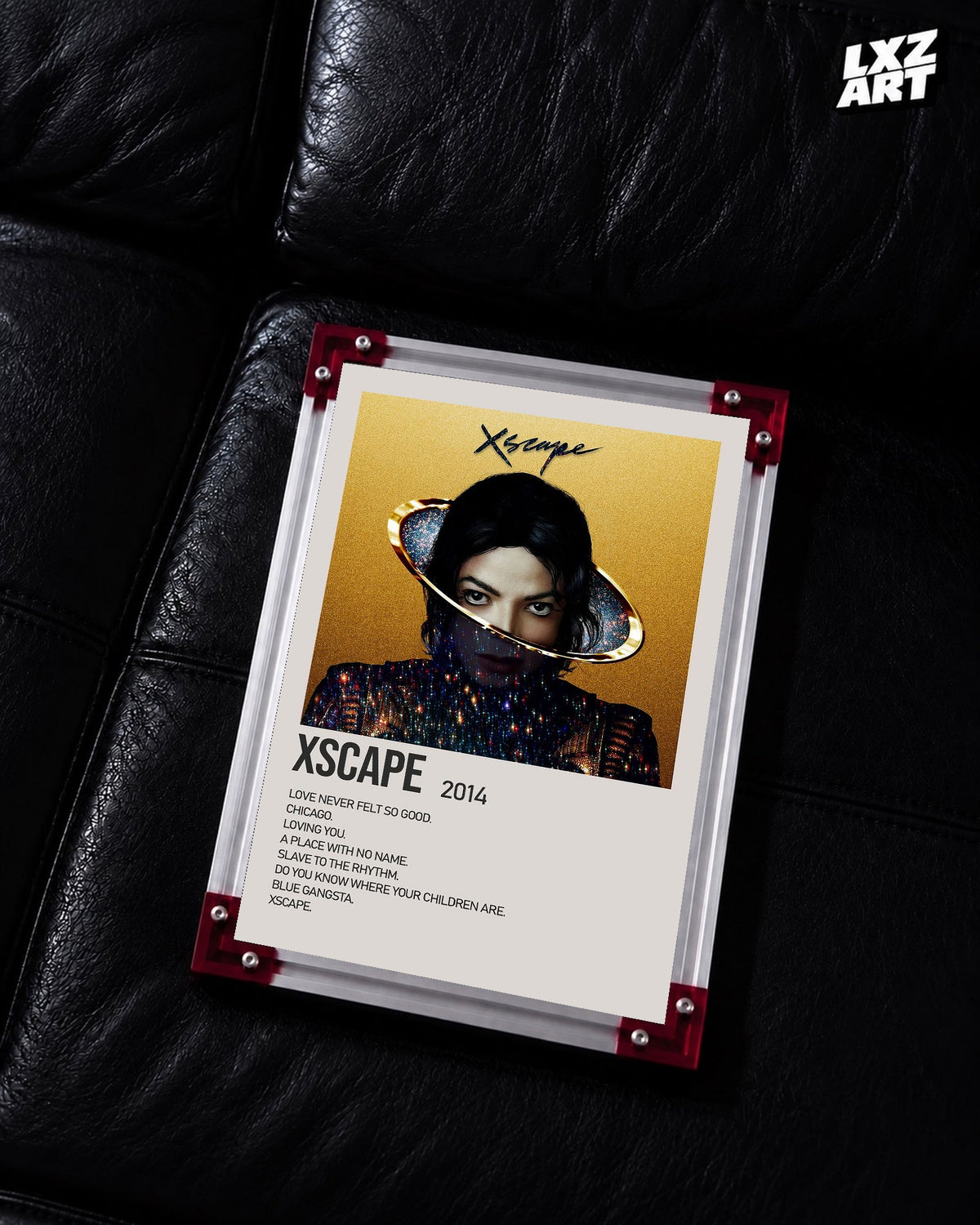 Michael Jackson Xscape Gold tracklist poster displayed on a black leather sofa in a red corner frame; unframed print, frame not included