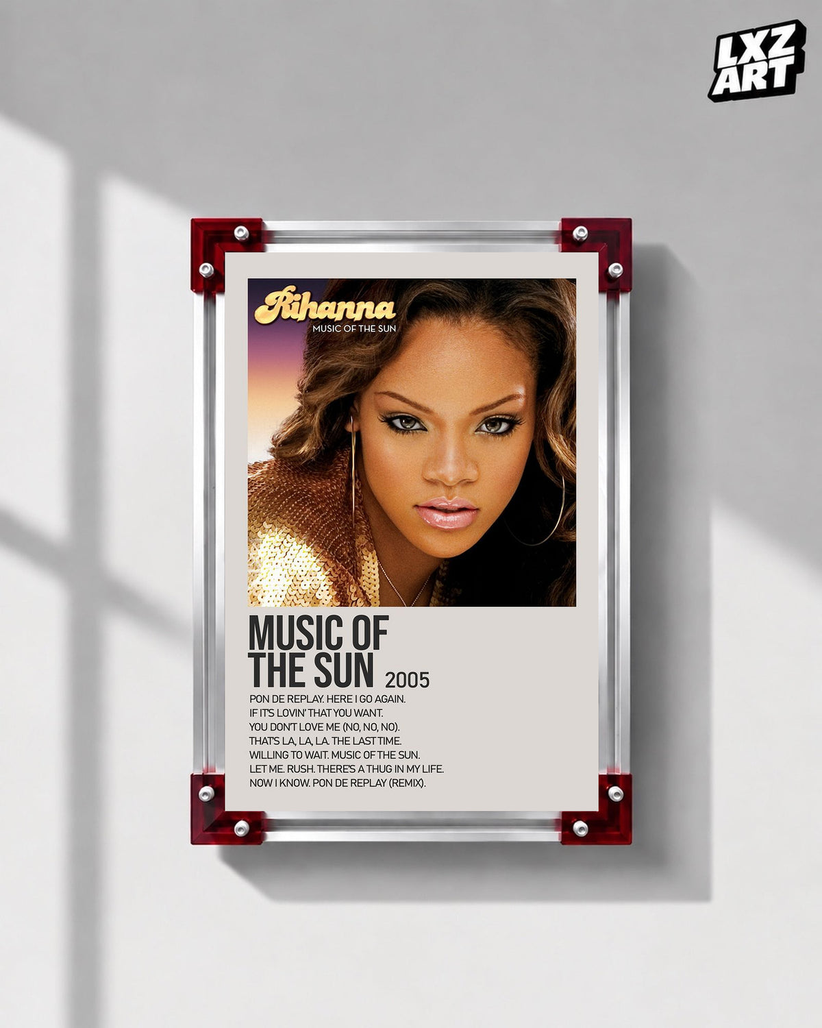 Rihanna Music of the Sun album tracklist poster displayed on a gray wall in a red corner frame; unframed print, frame not included