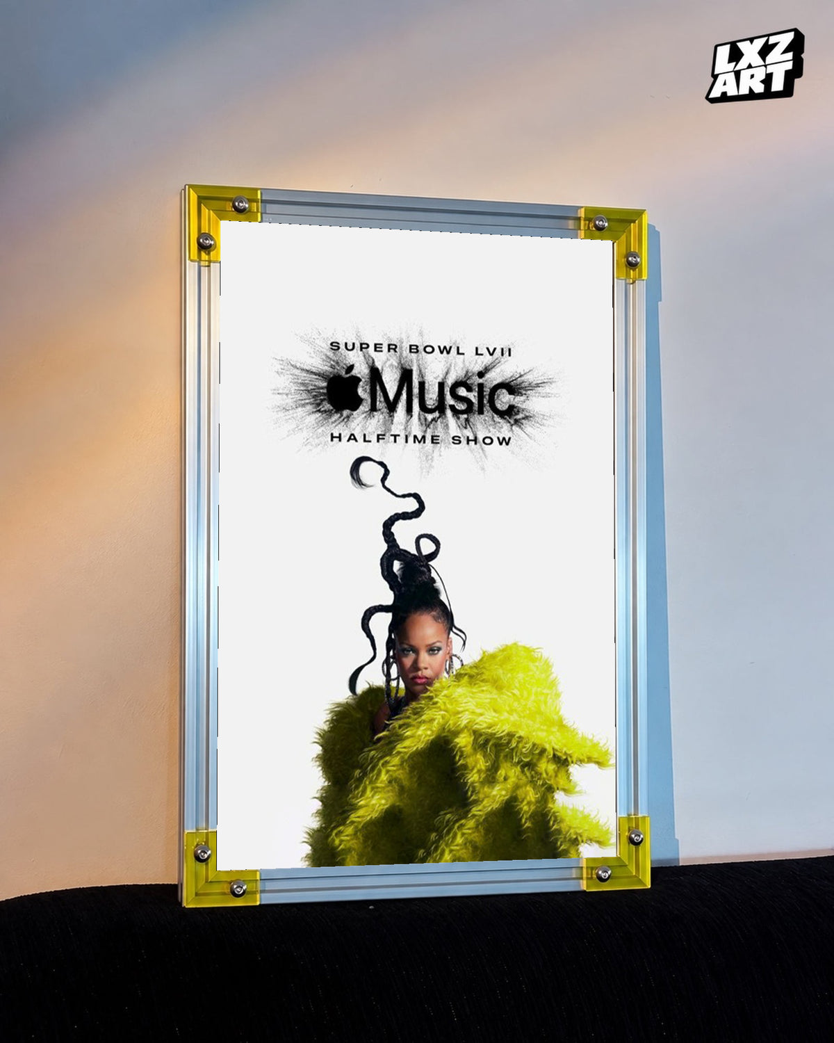 Rihanna Apple Music Super Bowl LVII Halftime Show performance poster displayed against a warm wall in a yellow corner frame; unframed print, frame not included