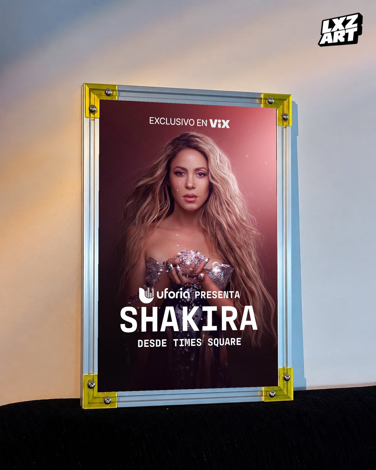 Shakira Desde Times Square live music special poster displayed against a warm wall in a yellow corner frame; unframed print, frame not included