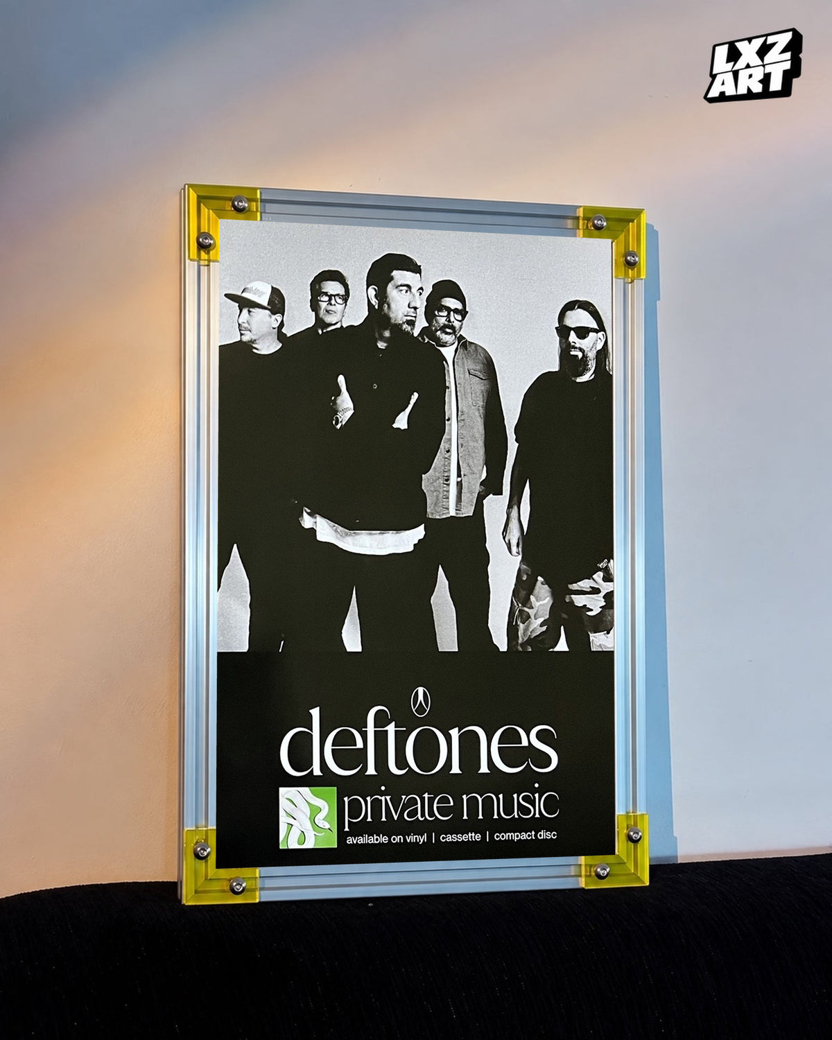 Deftones Private Music Monochrome Band Album Poster displayed against a warm wall in a yellow-corner frame; unframed print, frame not included