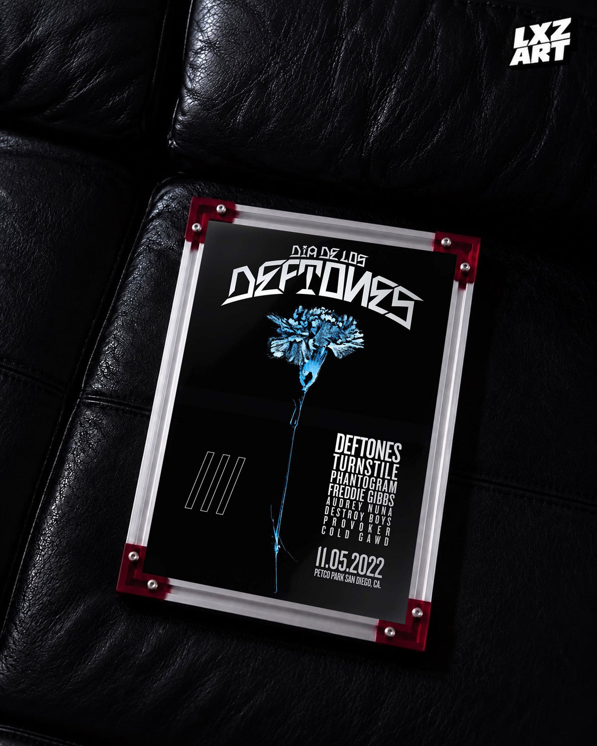 Deftones Dia de los Deftones 2022 Blue Flower Festival Poster displayed on a black leather sofa in a red-corner frame; unframed print, frame not included